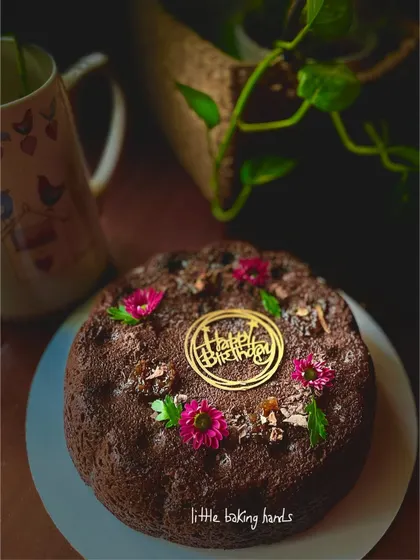 Another shot of the beautiful gluten-free and vegan chocolate gulkand cake, decorated with edible flowers.