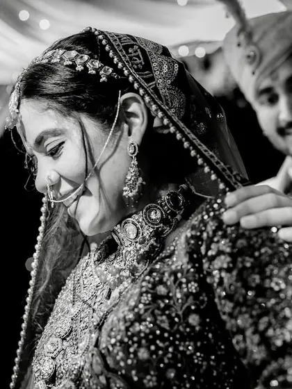 A beautiful black and white shot of a quiet moment during the ceremony. The groom's gentle touch on the bride's shoulder is full of care.