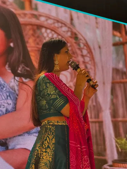 A side profile of me hosting, with a beautiful picture of the couple on the screen behind me. The event is always centered around their story.