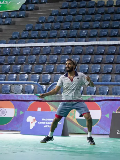 Raghu Mariswamy in a ready stance during an international match, showcasing the athletic posture we instill in our players.