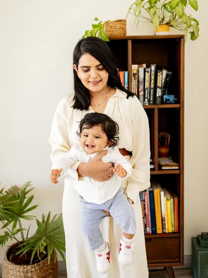 A mother and her baby sharing a happy moment in a classic wooden chair. I love finding unique spots in your home that make for beautiful portraits.