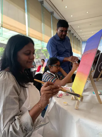 A family enjoying the BMW painting station. It was a great way to engage guests of all ages at a luxury car event.