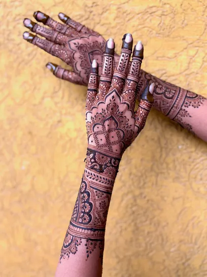 Another creative pose showing the intricate work on the back of the hands and arms.