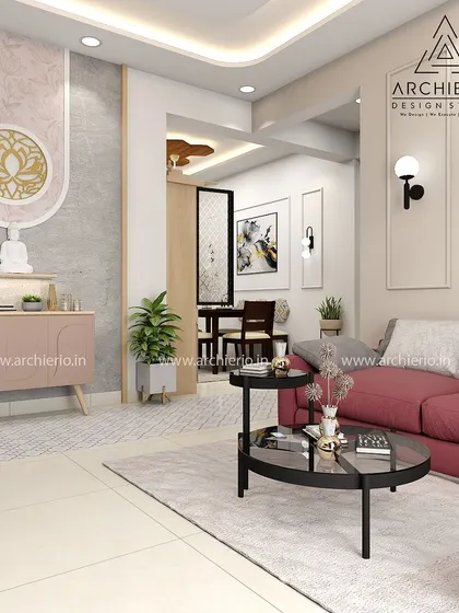 This living room uses a bold red sofa to make a statement. The space is balanced with a serene pooja corner and neutral walls, creating a home that is both vibrant and peaceful.