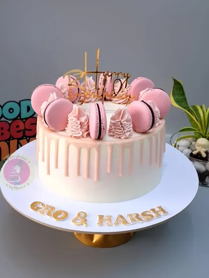 A beautiful pink drip cake with macarons, which traveled all the way to Hong Kong for a celebration.
