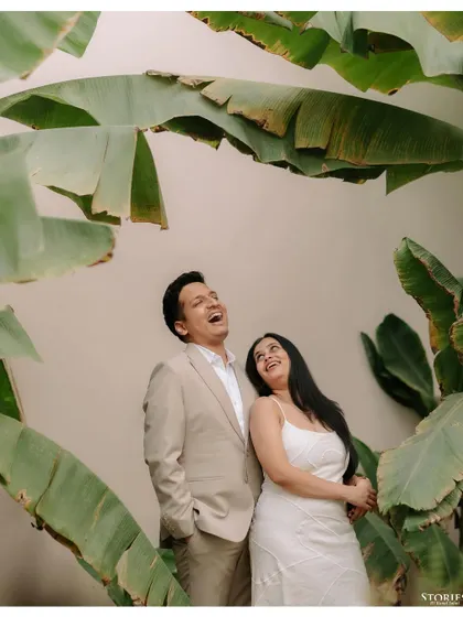 A moment of pure, uninhibited laughter shared between a couple, framed by large banana leaves. This candid shot from their Varanasi trip is full of life and joy.