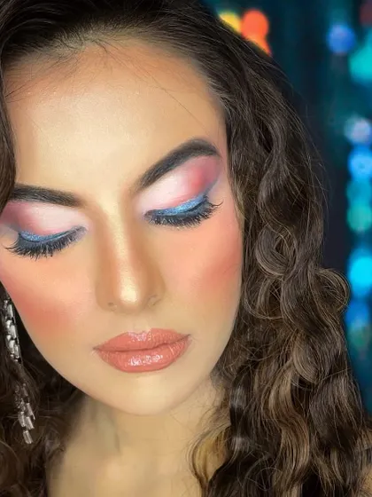 A beautiful evening glam look with a pop of blue and pink. The close-up shot shows the importance of detailing and blending for a seamless finish.
