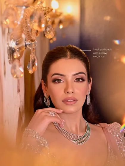 This shot highlights the sleek pull-back hairstyle with wavy elegance, which keeps the look modern and fresh.
