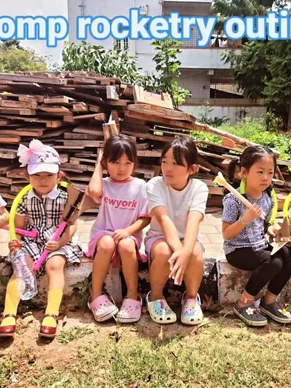 A group of young rocketeers takes a break during our stomp rocketry outing. They built their launchers and rockets from scratch.
