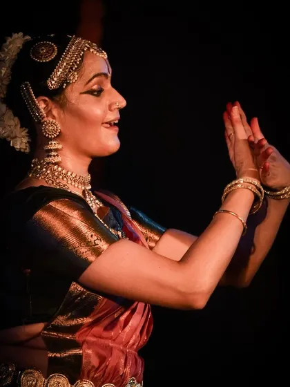 The expressive hands and face of the dancer, conveying the story's emotions.