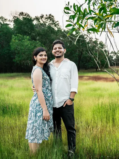 A happy and relaxed couple portrait in a natural, green setting.