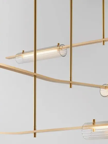 A detailed shot of the Volant system with a brass finish and clear glass, highlighting the precision of its machined components.