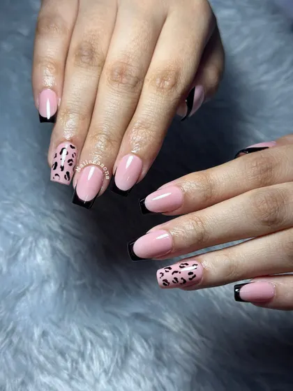 Another look at this classy yet wild design with black French tips and leopard print accents.
