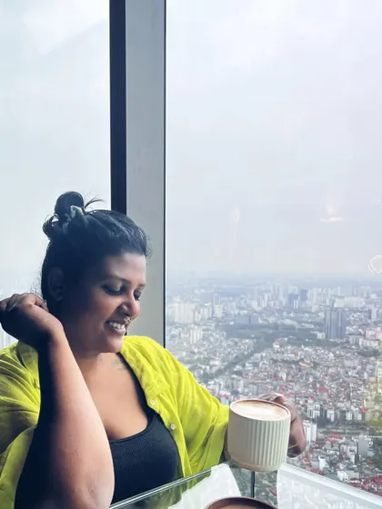 Enjoying a coffee with a view over Hanoi. Even a simple messy bun and a comfy shirt can feel chic when you're happy and relaxed.