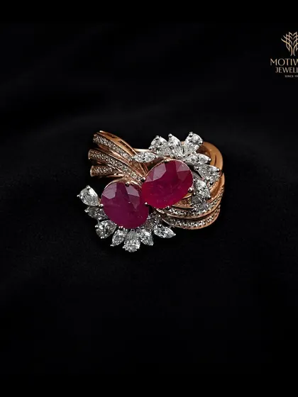 A truly extravagant design, this ring features two large rubies surrounded by a whirlwind of marquise and round diamonds. It is a masterpiece of movement and luxurious design.