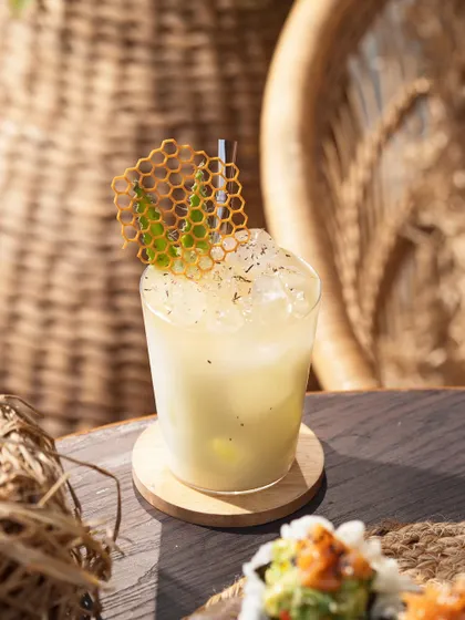A light and refreshing cocktail with a honeycomb tuile. The bright, sun-drenched setting gives this a perfect beach-side, vacation feel.