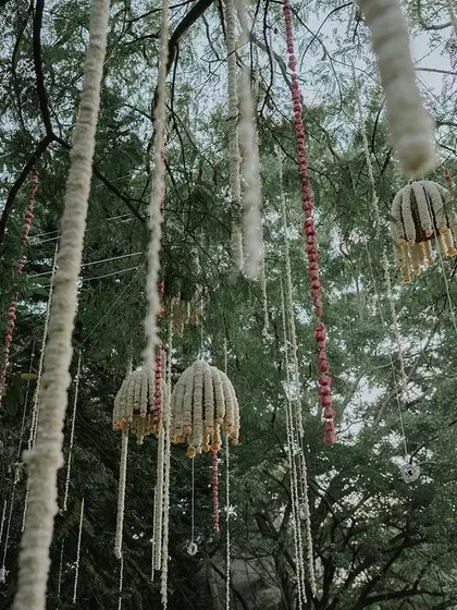 A close-up of the hanging floral decor, featuring jasmine bells and other traditional elements.