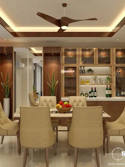 This dining area showcases a beautiful custom-built crockery unit with glass-front cabinets and integrated lighting. The warm wood tones and tufted dining chairs create a welcoming and elegant atmosphere for family meals.