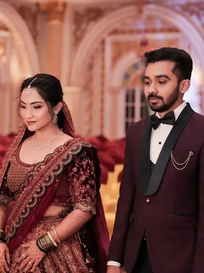 A candid moment of the couple. The bride's makeup is flawless even in an unposed shot.