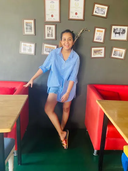Looking happy and confident, this client is enjoying the results of her hard work. Her journey is a great example of how our workouts help with postpartum body toning and reclaiming a sense of self.