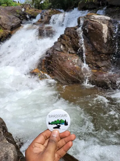 Our badge against a rushing stream on the way to Bandaje Falls.