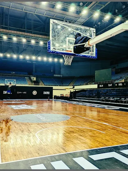 A wide shot of the professional court at the Thyagaraj Sports Complex during an INBL event. This is the stage where dreams are chased and champions are made.