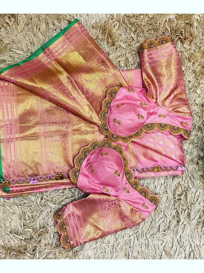 A flat lay of the pink saree and blouse, showing how the two pieces are designed to be a perfect match.