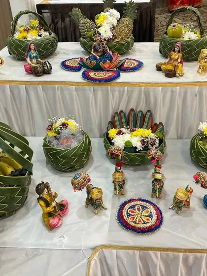 A beautiful display of eco-friendly fruit baskets and miniature decorative items for a baby shower table setup.