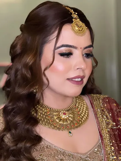 A close-up of the makeup, showing the soft brown smokey eye with a touch of gold glitter and a matte nude lipstick.