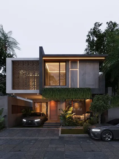 This Bangalore home features a decorative screen with a geometric pattern, a green wall of hanging plants, and dramatic exterior lighting.