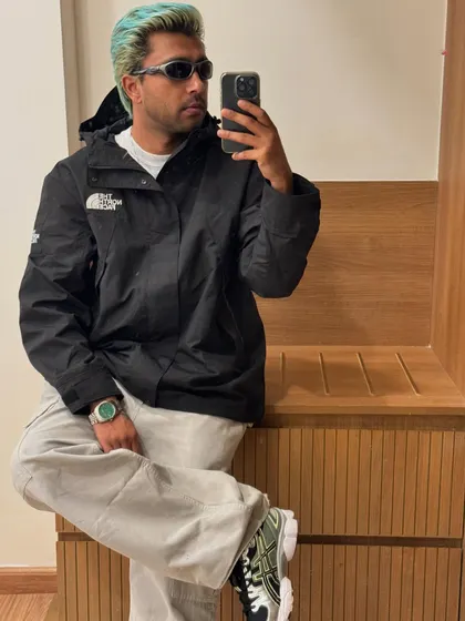 A pre-show fit check, leaning against a wooden bench.