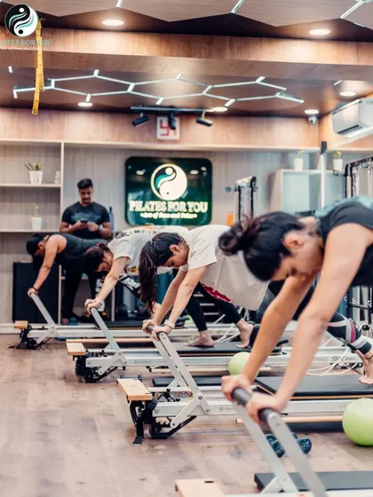 The plank hold is a staple for building core endurance. Here, a group holds the position with excellent form, showcasing their strength and focus.