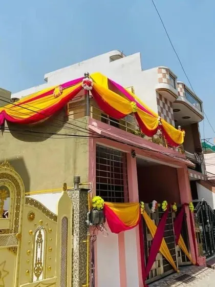 Another angle of the house decoration, showing how the drapes and floral elements create a festive look from the street.
