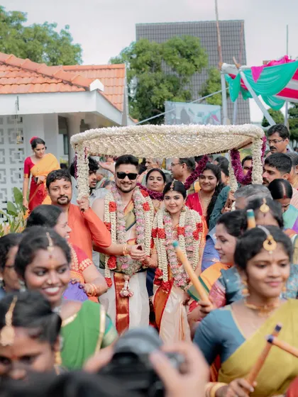 The grand procession for Varun and Priya's wedding, with dancers and family leading the way. The energy and excitement are palpable in this shot.