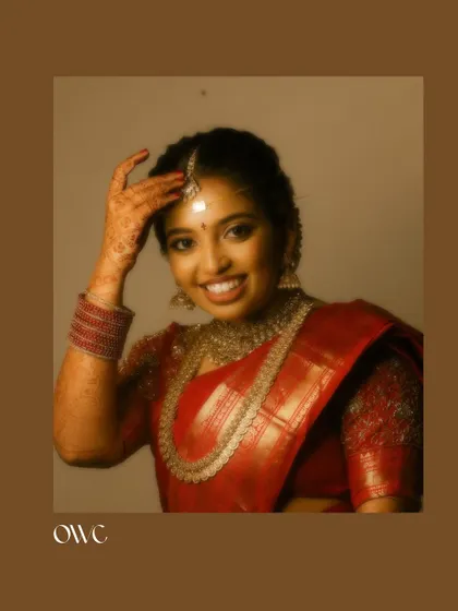A warm, classic portrait of the bride, framed in a brown border.