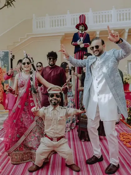 The couple's energetic and fun-filled entry at their carnival-themed event, a perfect example of a wedding that is full of personality.