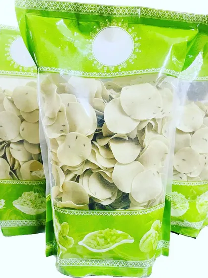 These are the jeera-flavoured coin-sized rice papads. They are homemade and perfect to fry and serve alongside rice and dal for extra crunch.