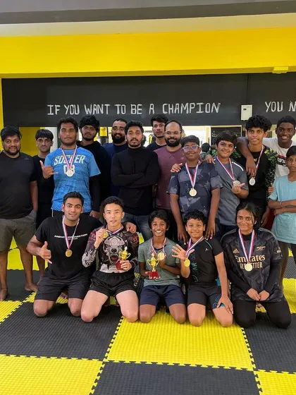 This is our team after a fun in-house jiu-jitsu competition. We believe in pushing each other to get better, and events like these build confidence and team spirit. You can see the mix of kids and adults, all proud of their hard work.