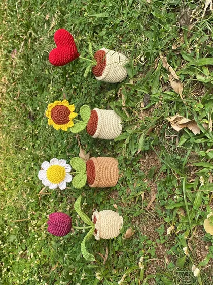 My four most popular designs enjoying a day out in the grass. A heart, sunflower, daisy, and tulip, each with its own unique pot and personality.