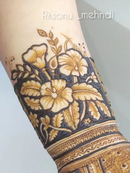 This design showcases a stunning floral cuff on the wrist. The bold, dark background makes the flowers pop, creating a dramatic and beautiful statement piece.