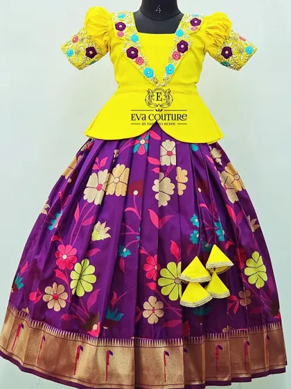 A yellow peplum top with delicate floral embroidery on the V-neckline. The colorful threadwork adds a beautiful detail to the blouse.