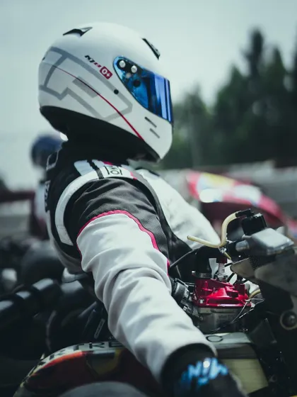 A close up of a driver in his helmet.