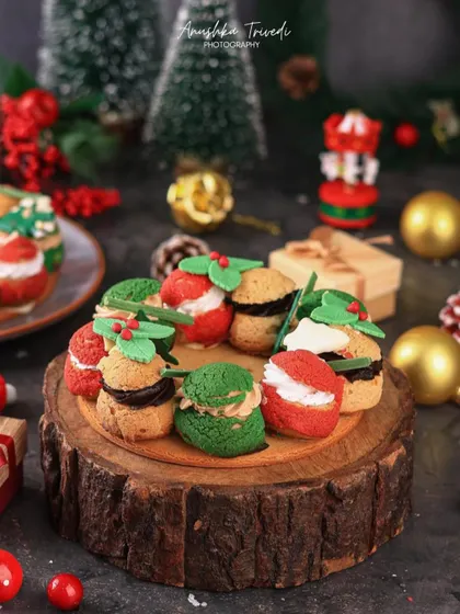The cream puff Christmas wreath styled with gift boxes and ornaments, making it the centerpiece of a holiday dessert table.