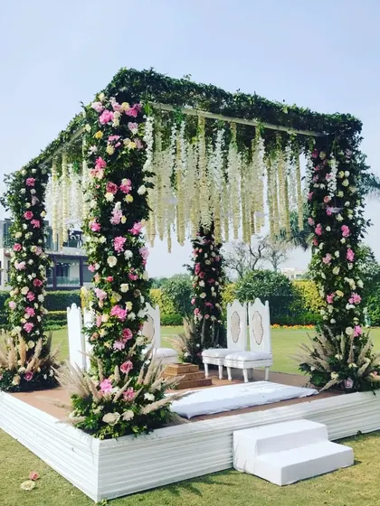 For this daytime garden wedding, I created a beautiful floral mandap. The structure is covered in fresh pink and white roses with hanging tuberose (rajnigandha) and greenery, creating a romantic and natural focal point for the ceremony.