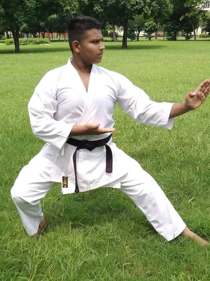 My brother demonstrating a perfect defensive stance during outdoor practice. We train together often, pushing each other to improve.