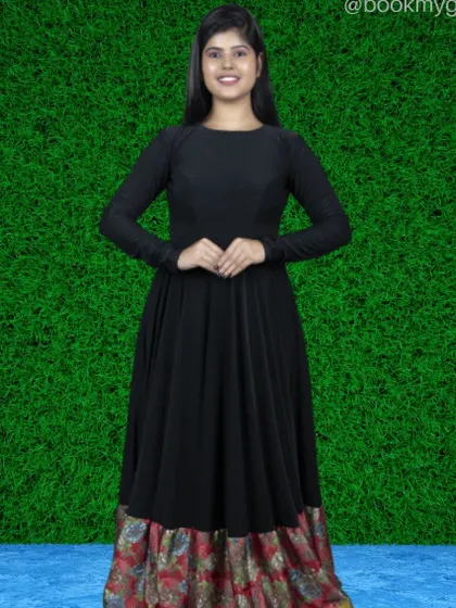 This black full-sleeve Anarkali-style dress features a colorful, traditional print on the lower border, blending modern style with ethnic design.