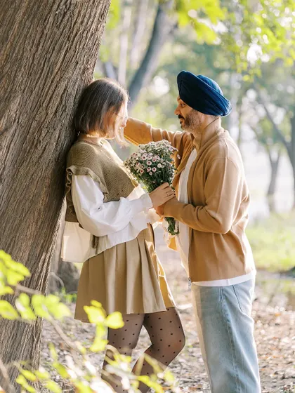A sweet, romantic moment in the woods. He offers her a bouquet of flowers, a classic gesture of love that I was happy to capture for their love story session.