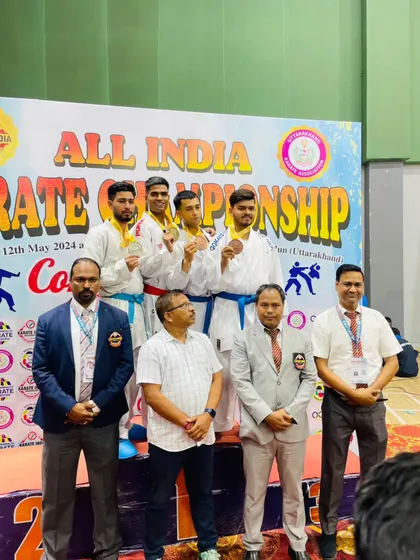 A group of medalists on the podium at the All India Karate Championship, showcasing the high level of competition.