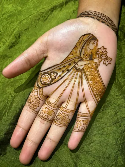 A simple yet incredibly elegant design featuring a single figure of a bride or 'dulhan' holding a flower. The fingers have delicate elephant bands, adding a touch of tradition to a minimalist design.