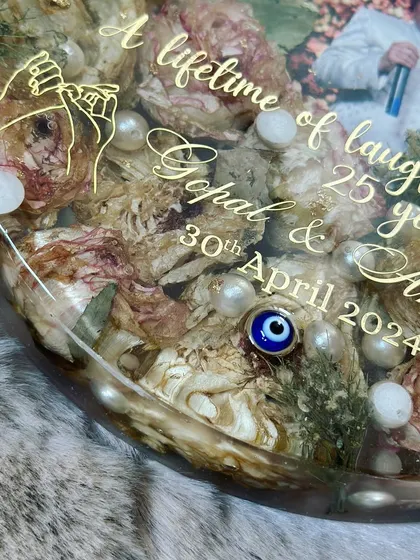 The personalized text on this anniversary piece makes it even more special. "A lifetime of laughter, 25 years of smile" beautifully captures the couple's journey, etched alongside their names and anniversary date.